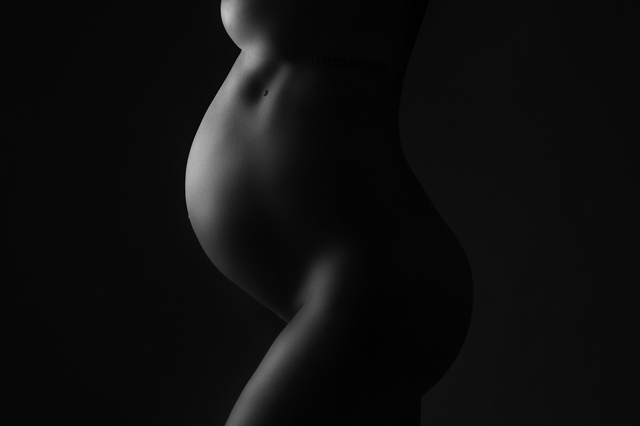 closeup of a baby bump in silhouette Maternity Stores in Atlanta