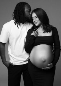 Black and white maternity portrait of couple touching foreheads