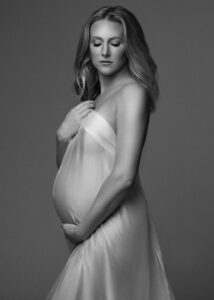 Ethereal maternity portrait in white fabric with soft natural posing