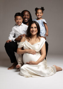 Family maternity photo with expecting mom, dad, and two kids