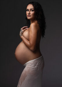Dramatic studio portrait with moody light and shadow