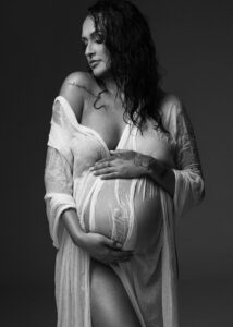 Editorial maternity photo in sheer white fabric