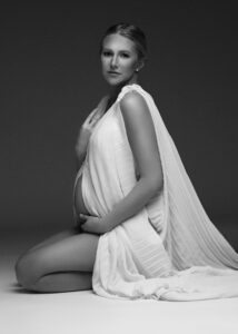 Fort Lauderdale fine art maternity photo with draped white fabric, seated pose